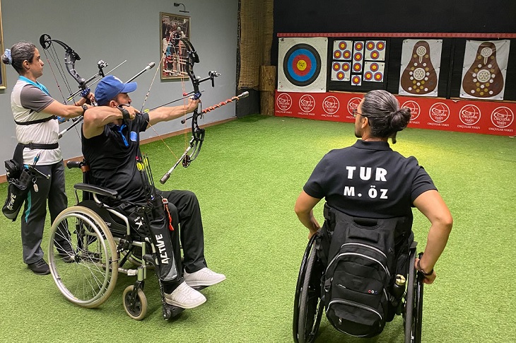 Murat Öz'ün antrenörlüğünde ok atışı yapan 2 sporcu objektife yansıyor.