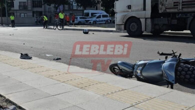 Trafik kazası olay yerinde polis ve elektrikli motosiklet yere düşmüş.