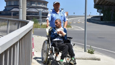 Hacı Bayram Doğan, tekerlekli sandalyede oturan Cengizhan'ı gezdiriyor.