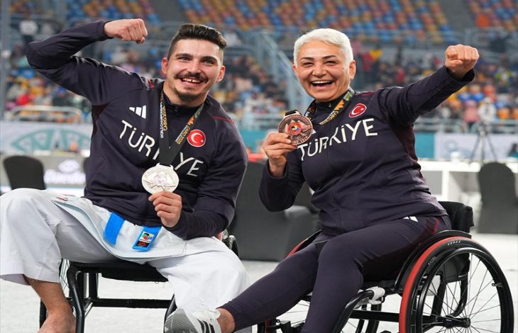 Milli sporcular Berkay Uslu ve Nesrin Cavadzade tekerlekli sandalyede oturarak kazandığı madalyalarla poz veriyor.