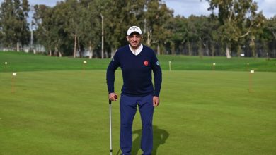 Engelli sporcu Mehmet Kazan golf sahasında değnek tutarak ayakta poz veriyor.