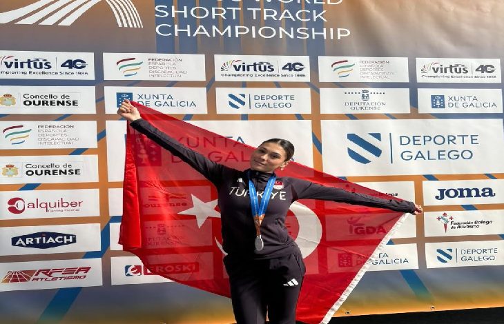 Milli Özel Sporcumuz Aysel Önder, sırtında tuttuğu Türk bayrağı ile beraber poz veriyor.